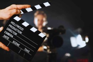 Ciak di un film con alle spalle la figura di un uomo appannato
