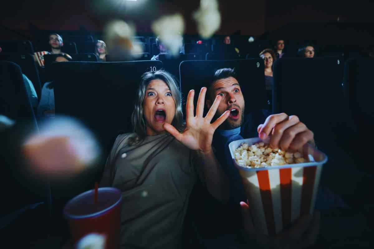 Persone che guardano un film spaventoso al cinema