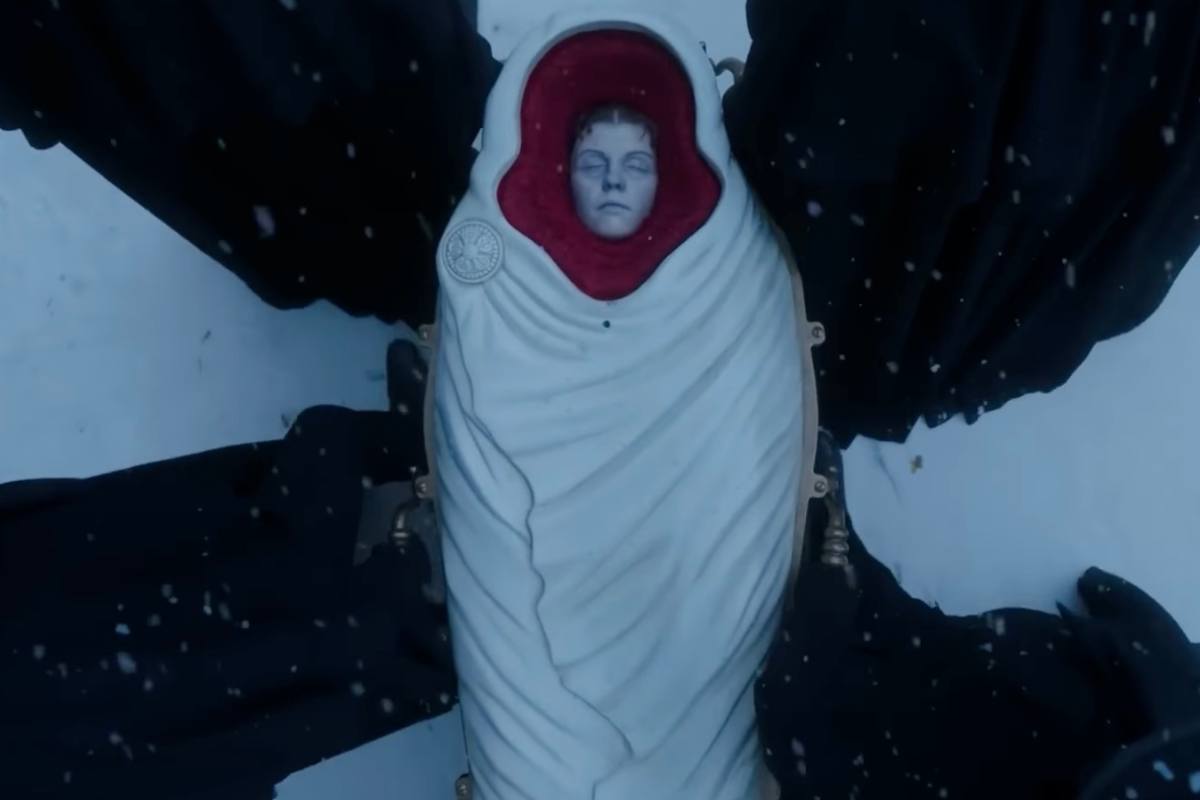 Una donna avvolta in una coperta bianca sulla neve