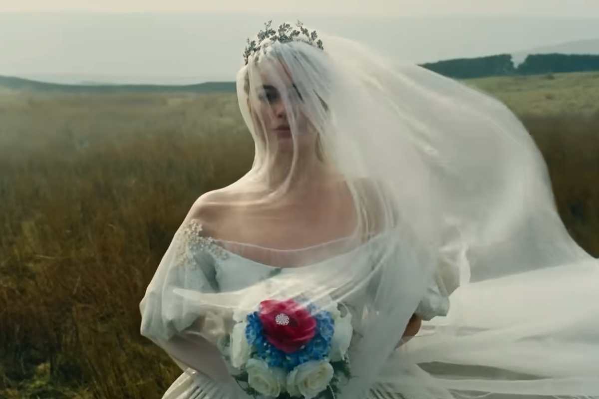 Margot Robbie in abito da sposa in una scena del film Cime Tempestose