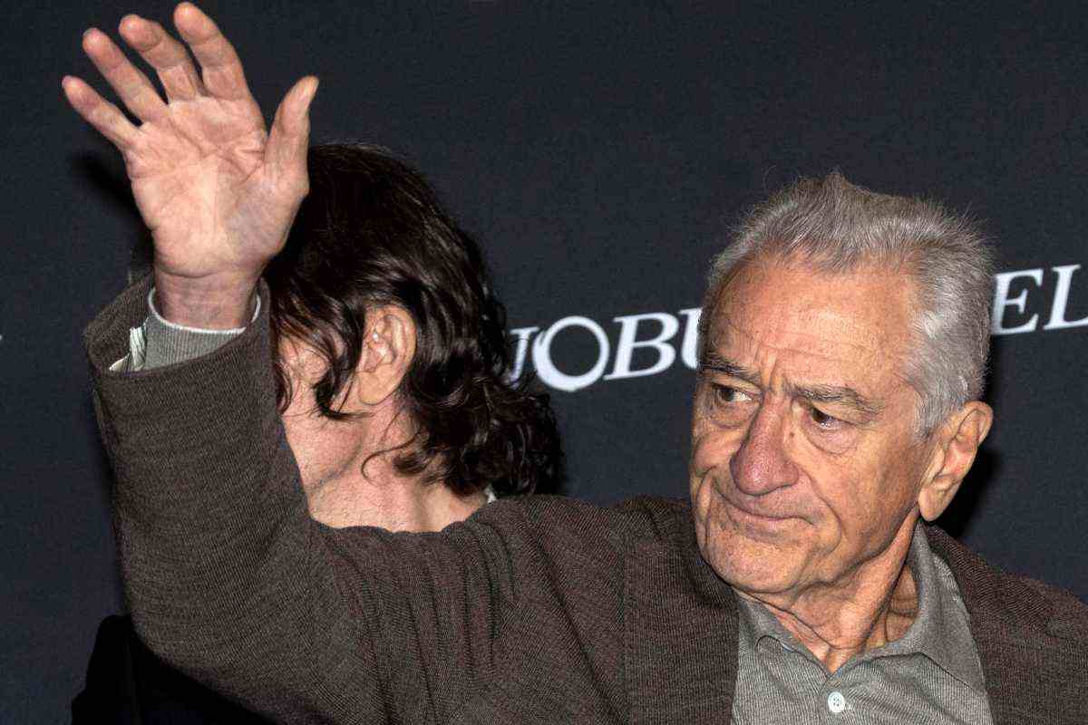 Robert De Niro con la mano destra alzata in segno di saluto 